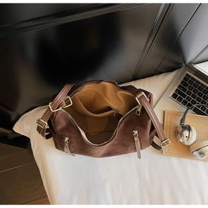 Inside view of dark brown suede tote showing spacious interior and zipper pocket