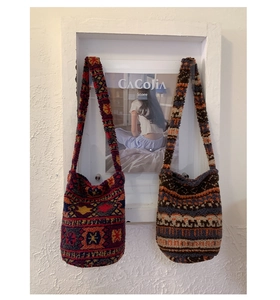 Detail of ethnic geometric patterned plush tote bags in bucket style with knit texture