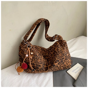 Detail of leopard print hobo bag with adjustable strap and decorative beaded tassels