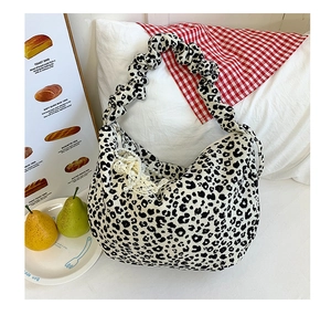 Detail of leopard print hobo bag with cloud-like pleated handle and lace pearl pendant