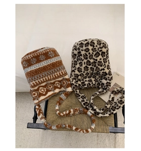 Detail of plush faux fur hats in tribal and leopard patterns with long ties