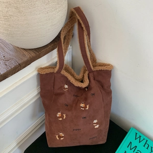 Detail of corduroy tote bag with puppy embroidery and soft lamb wool lining