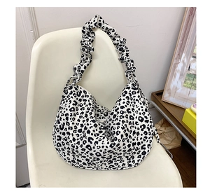 Detail of leopard print tote bag featuring a pleated cloud-style shoulder strap design