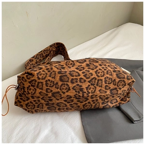 Detail of leopard print tote bag with soft fabric texture and drawstring closure