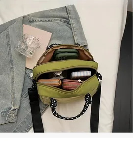 Detail of multi-compartment canvas bag showing spacious interior for phone and wallet
