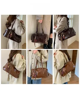 Detail view of vintage underarm bags in dark brown and caramel with heart charms