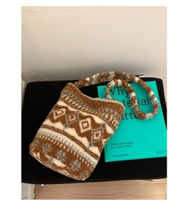 Close-up of geometric ethnic pattern on soft fleece bucket bag with plush texture