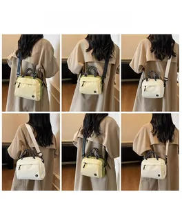 Detail of light green and beige crossbody bags with woven handles and adjustable straps