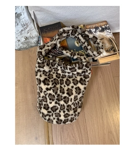 Close-up of fluffy leopard print faux fur bucket bag with plush handle detail