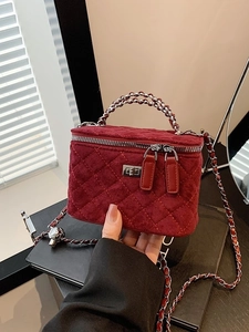 Quilted burgundy suede vanity bag with silver chain strap and crossbody design