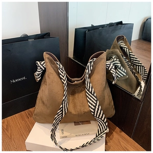 Brown frosted suede tote bag with decorative black and white striped wide woven shoulder strap