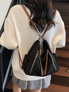 Matte black oversized retro tote bag with brown leather straps shown on a model
