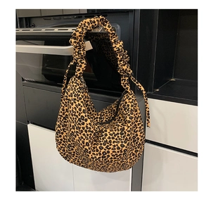 Detailed close-up of leopard print shoulder bag with large pleated ruffle strap design