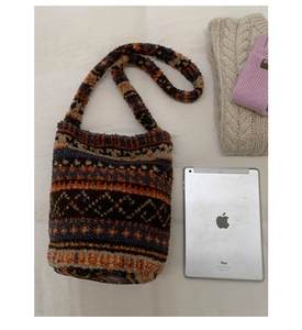 Close-up of bohemian plush knit tote bag with ethnic geometric patterns in blue and orange