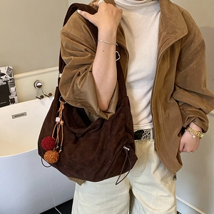 Retro dark brown suede hobo tote bag with drawstring side and plush pom-pom charm