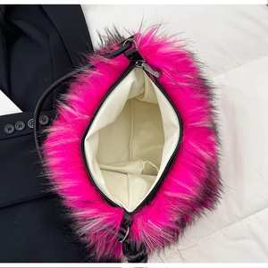 Detail view of the plush magenta shoulder bag showing interior lining and black metal zipper