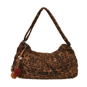 Leopard print tote bag with plush pom-pom charm and dual shoulder straps on white background