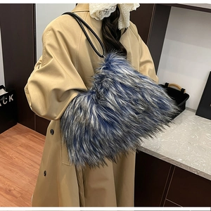 Blue-grey faux fur tote bag styled with khaki trench coat in a cozy indoor setting