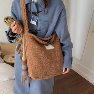Detailed texture of brown fleece tote bag featuring toggle closure and SEEYOU patch detail