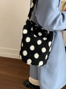 Fuzzy faux shearling tote bag with large black and white polka dots for women