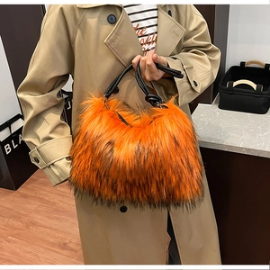 Detail of vibrant orange faux fur handbag with knotted black leather handle on a trench coat