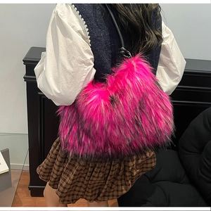 Detail view of the long-haired faux fur texture on this vibrant pink shoulder bag