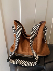 Brown frosted suede tote bag with stylish black and white woven wide shoulder strap
