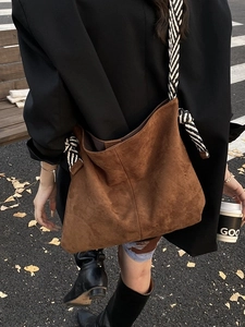 Brown faux suede large bucket tote bag with striped rope shoulder strap for women