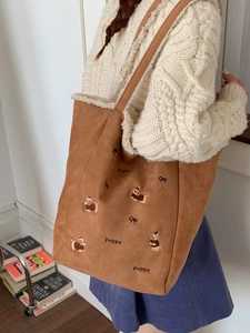 Brown corduroy shoulder bag with puppy embroidery and white faux shearling lining