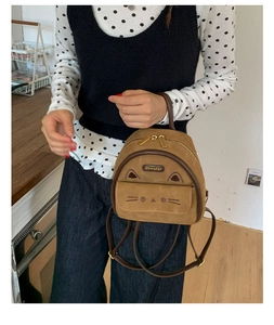 Close-up of brown leopard print mini backpack with cute cat ears and face embroidery