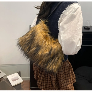 Detail shot of plush faux fur shoulder bag with textured black and brown patterns