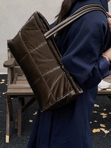 Quilted dark brown padded tote bag with metallic finish for autumn winter outfits