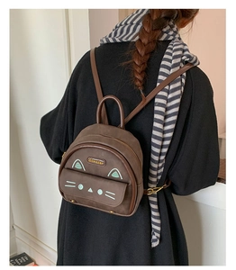 Detail of a mini leopard brown backpack with cute cat design elements and adjustable straps