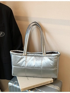 Modern silver metallic quilted tote bag with padded shoulder straps for urban commuting