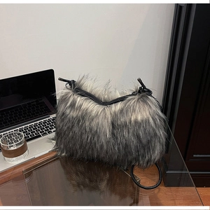 Detail of plush faux fox fur handbag showing soft grey-black gradient texture and zipper