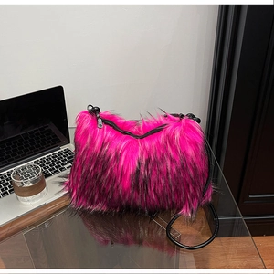 Detail of fuchsia and black faux fox fur shoulder bag with metal zipper and strap