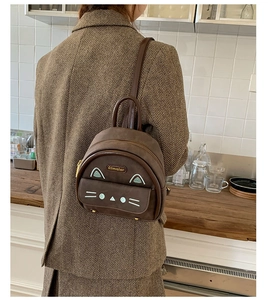 Brown mini cat backpack shown on model with shoulder strap and kitten ear details