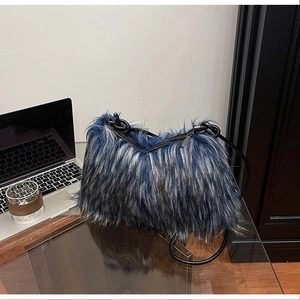 Detail of blue and grey plush faux fur texture on a shoulder bag with black zip