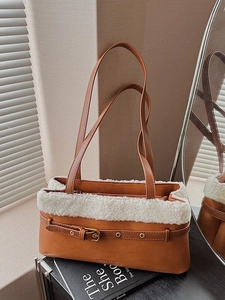 Brown leather shoulder bag with white faux fur trim and gold buckle for winter fashion