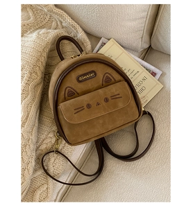 Close-up of brown cat-themed mini backpack in suede with cute ears and metal logo