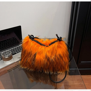 Detailed close-up of orange and black faux fur texture with knotted tube handles