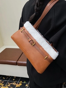 Brown faux leather shoulder bag with white fleece trim and decorative metal buckle strap