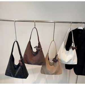 Detailed view of leather hobo bags in four colors with cute dachshund dog charms
