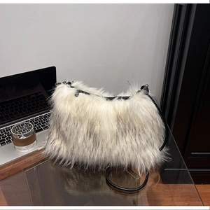 Close-up of white and grey faux fur texture on a modern crossbody bag with zipper