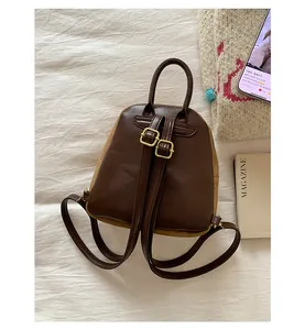 Close-up of adjustable shoulder straps and brown faux leather back of a mini cat backpack