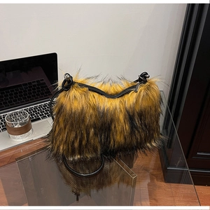 Detail of yellow and black faux fox fur texture and top zipper on shoulder bag