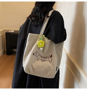 Detailed texture of beige corduroy tote bag featuring a cute dachshund puppy embroidery