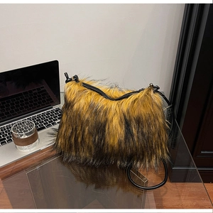 Detail of yellow and black faux fur handbag with leopard texture and leather strap