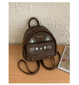 Detailed view of mini cat backpack in dark brown faux leather with cute embroidery