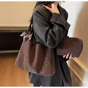 Detail of coffee brown suede tote bag set with matching pouch and dog charm decoration